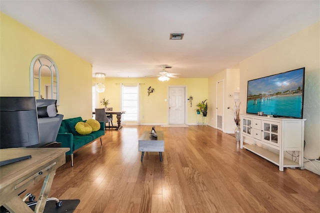 living room with ceiling fan and wood-type flooring