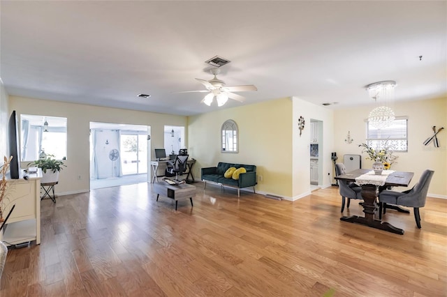 living room with light wood-type flooring and ceiling fan