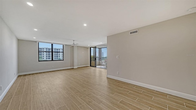 unfurnished room with ceiling fan and light hardwood / wood-style flooring