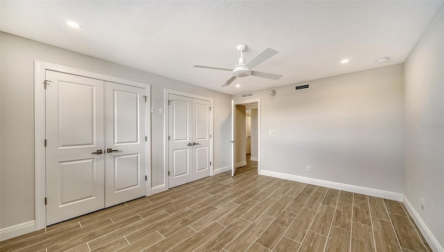5760 Midnight Pass Rd Unit 307D, Sarasota, FL 34242 - unfurnished bedroom with multiple closets, light wood-style floors, recessed lighting, and a ceiling fan