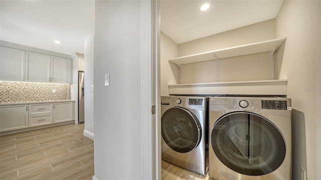 5760 Midnight Pass Rd Unit 307D, Sarasota, FL 34242 - laundry room featuring washing machine and clothes dryer, light wood-style flooring, and recessed lighting