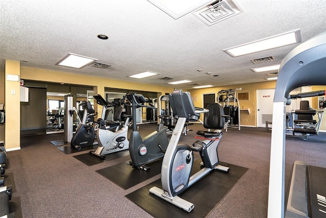 gym featuring a textured ceiling