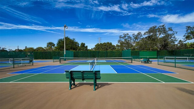 view of tennis court with basketball hoop