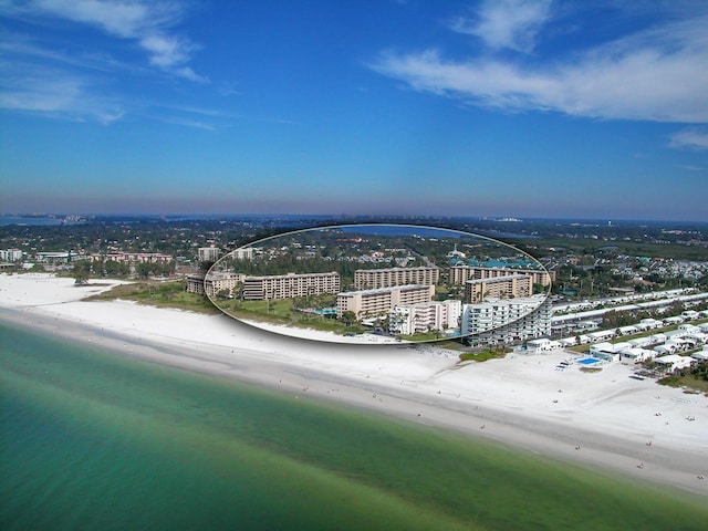 bird's eye view with a water view and a beach view