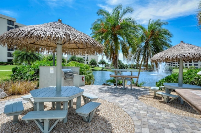 view of patio with a water view and area for grilling