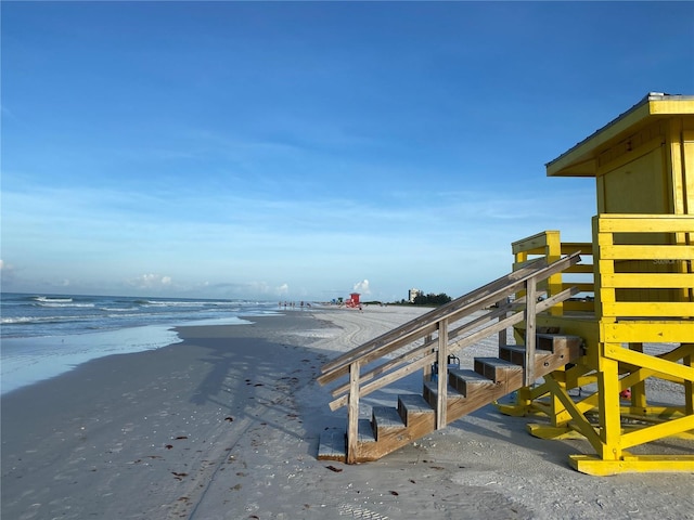 view of dock with a view of the beach and a water view