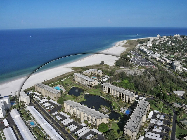 birds eye view of property with a view of the beach and a water view