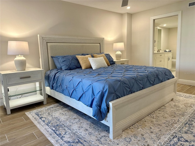 5760 Midnight Pass Rd Unit 307D, Sarasota, FL 34242 - bedroom with wood finished floors, ensuite bath, and recessed lighting