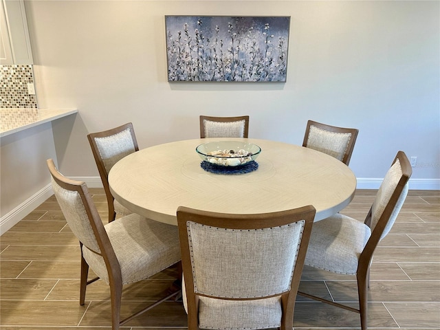 5760 Midnight Pass Rd Unit 307D, Sarasota, FL 34242 - dining area with baseboards and wood tiled floors