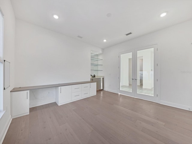 unfurnished office featuring recessed lighting, wood finished floors, visible vents, french doors, and baseboards