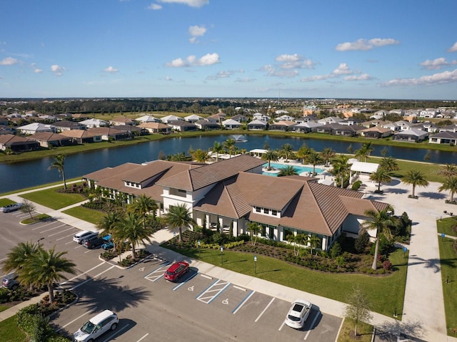 drone / aerial view featuring a residential view and a water view