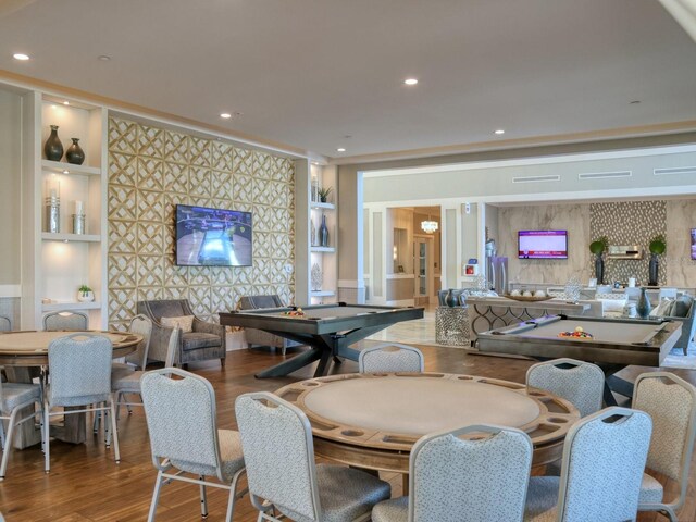 dining area with wood finished floors, recessed lighting, and built in shelves