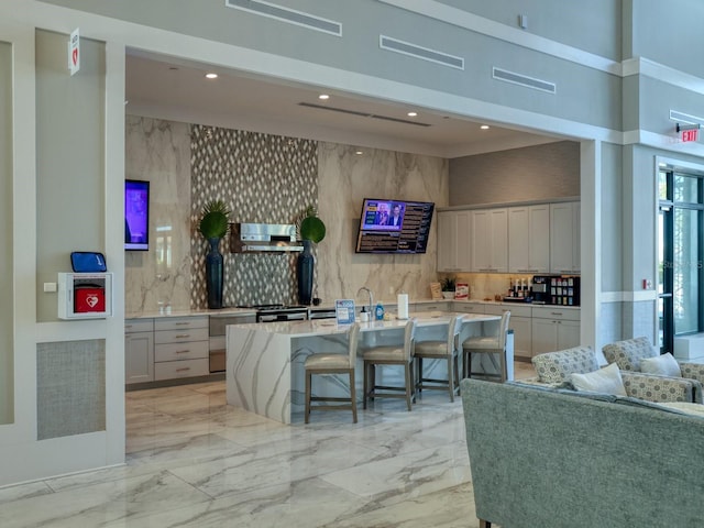 5058 Surfside Cir, Lakewood Ranch, FL 34211 - living room featuring a towering ceiling, light marble finish flooring, and recessed lighting