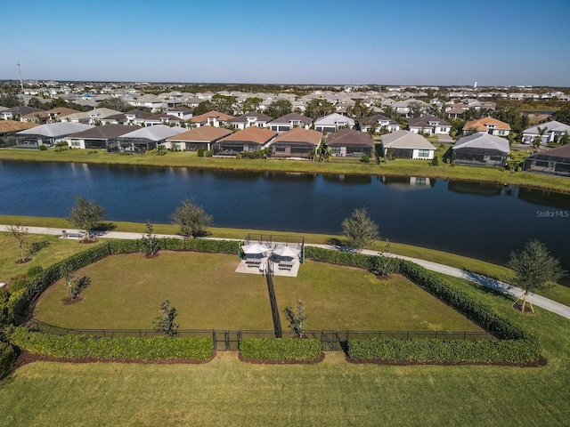 birds eye view of property with a water view and a residential view