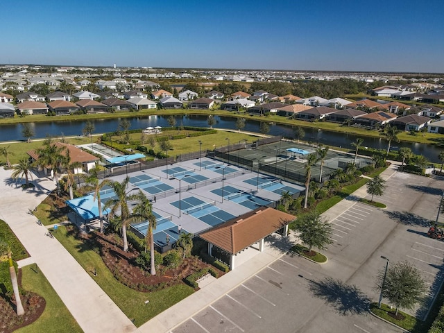 drone / aerial view with a water view and a residential view