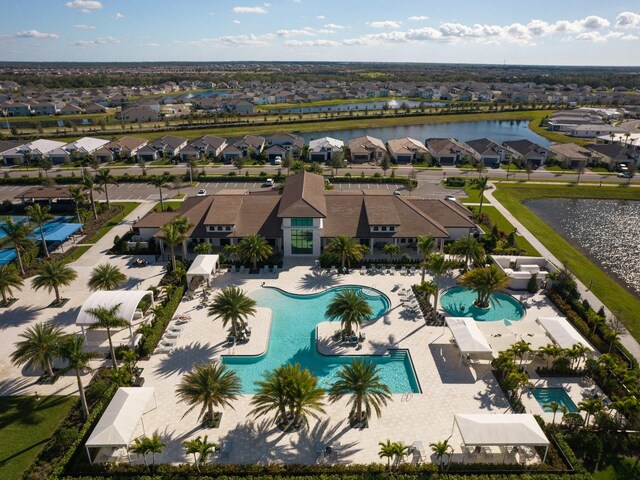 birds eye view of property with a residential view and a water view