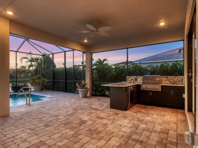 5058 Surfside Cir, Lakewood Ranch, FL 34211 - patio terrace at dusk with an outdoor kitchen, a patio area, a ceiling fan, an outdoor pool, and a lanai