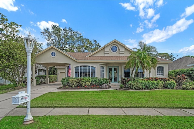 view of front of house with a carport, a front lawn, and french doors