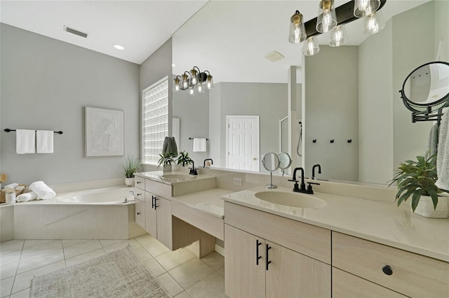 bathroom featuring a bathing tub, tile patterned flooring, and vanity