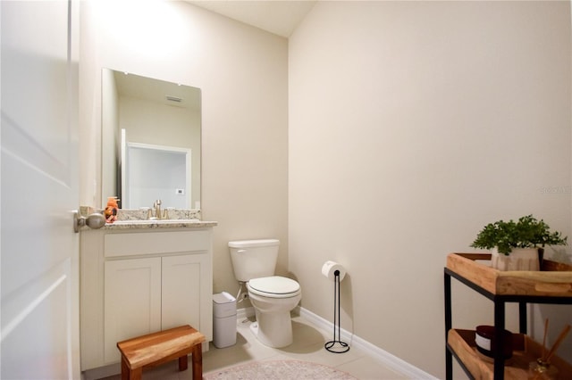 16926 Harvest Moon Way, Bradenton, FL 34211 - half bath with toilet, vanity, tile patterned floors, and baseboards