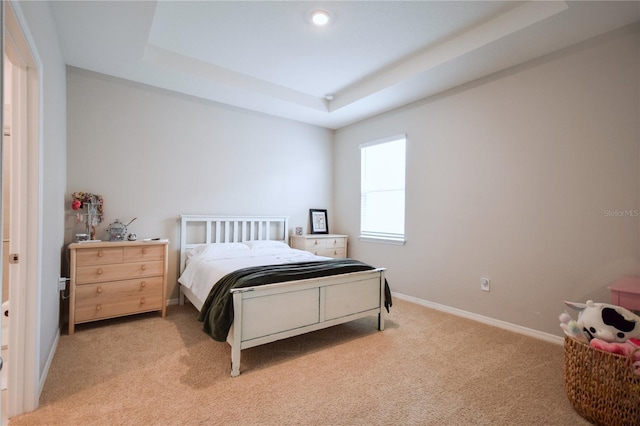 16926 Harvest Moon Way, Bradenton, FL 34211 - bedroom with light carpet, a raised ceiling, baseboards, and recessed lighting