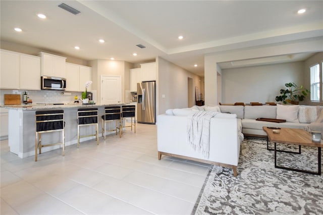 16926 Harvest Moon Way, Bradenton, FL 34211 - living room featuring recessed lighting and light tile patterned flooring