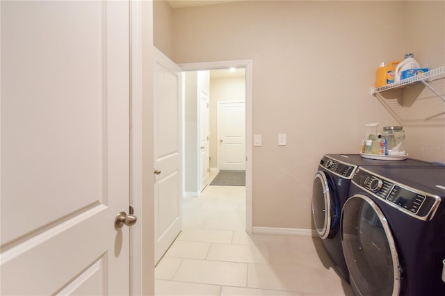 16926 Harvest Moon Way, Bradenton, FL 34211 - laundry room featuring washing machine and clothes dryer, light tile patterned floors, and baseboards