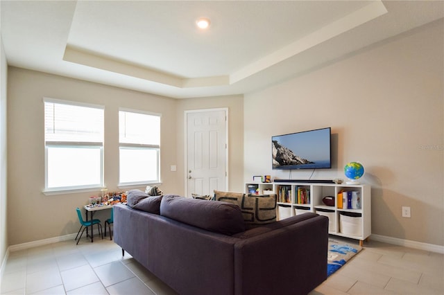 16926 Harvest Moon Way, Bradenton, FL 34211 - living room with baseboards, a raised ceiling, and light tile patterned floors