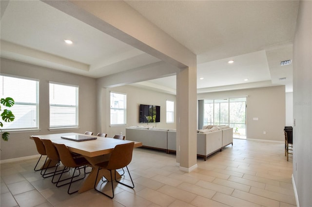 16926 Harvest Moon Way, Bradenton, FL 34211 - dining area featuring a raised ceiling, healthy amount of natural light, baseboards, and recessed lighting