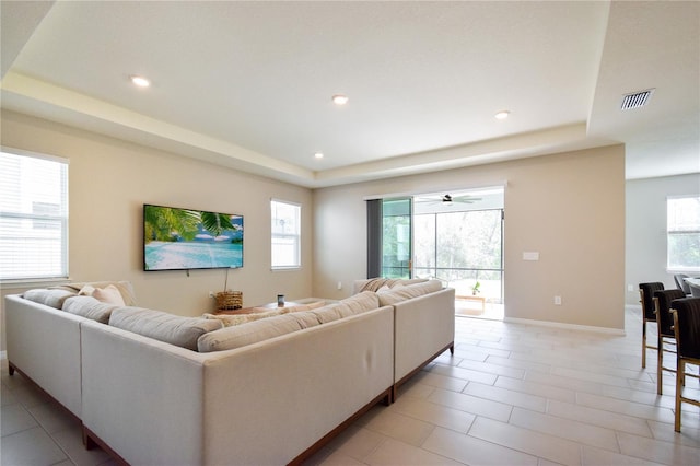 16926 Harvest Moon Way, Bradenton, FL 34211 - living room with a tray ceiling, recessed lighting, baseboards, a ceiling fan, and light tile patterned flooring