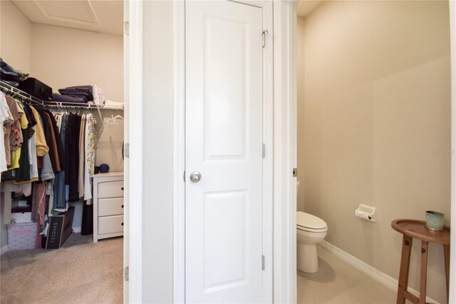 16926 Harvest Moon Way, Bradenton, FL 34211 - bathroom featuring toilet, baseboards, and a walk in closet