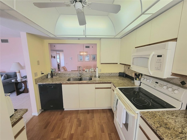 kitchen featuring pendant lighting, white appliances, dark wood-type flooring, white cabinets, and sink