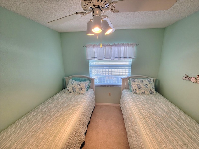 unfurnished bedroom with ceiling fan, light colored carpet, and a textured ceiling