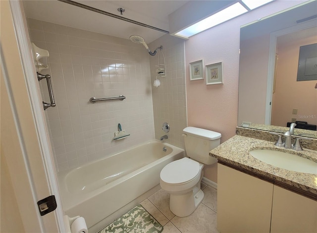 full bathroom featuring tiled shower / bath, tile patterned flooring, vanity, and toilet