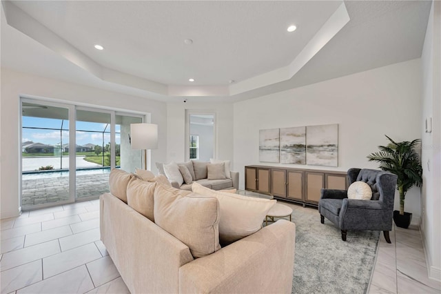 tiled living room featuring a raised ceiling