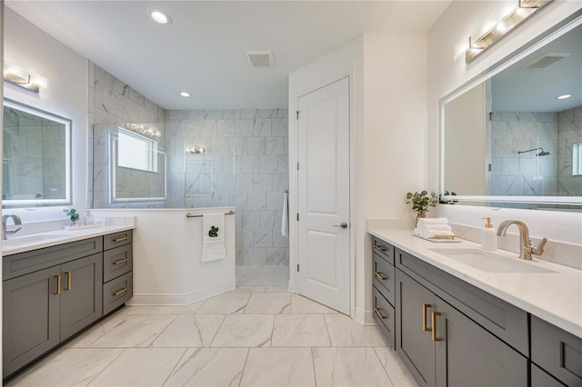 bathroom with vanity and tiled shower