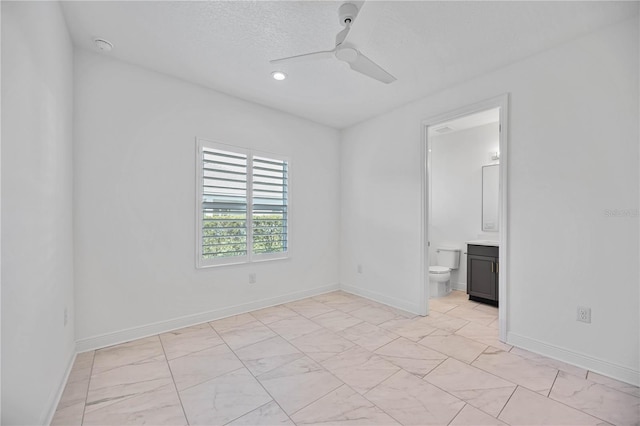 empty room with a textured ceiling and ceiling fan