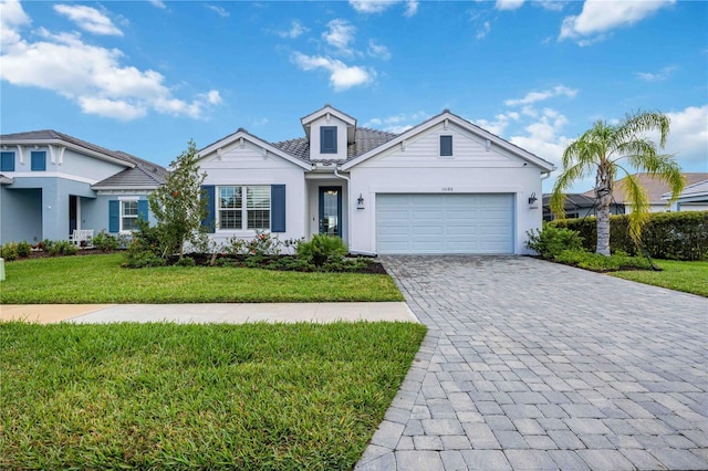 view of front of property with a front yard and a garage