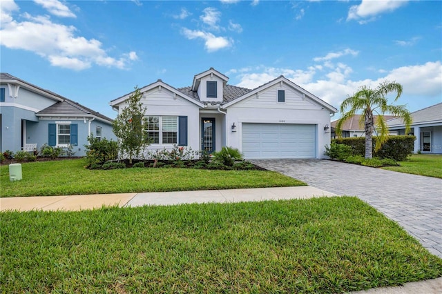 view of front of property featuring a front yard and a garage