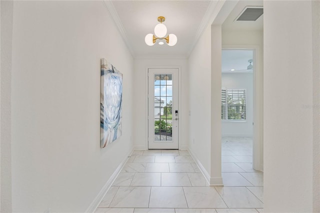 doorway to outside featuring a notable chandelier and ornamental molding