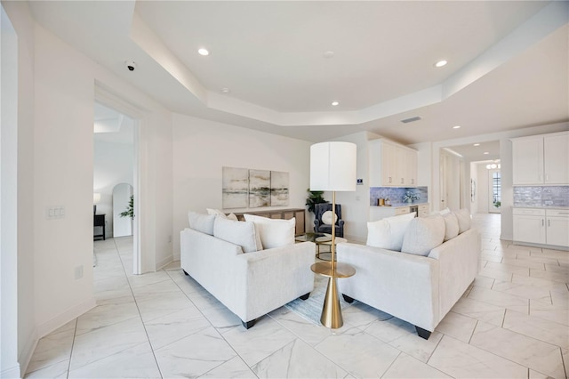 living room with a raised ceiling