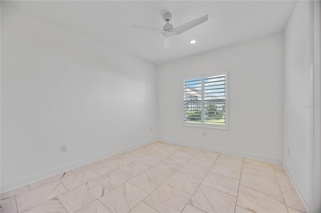 spare room featuring ceiling fan and a textured ceiling