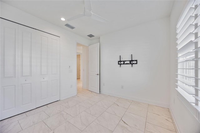 unfurnished bedroom featuring a closet and ceiling fan