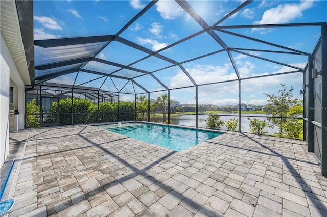 view of pool featuring a patio, a water view, and glass enclosure