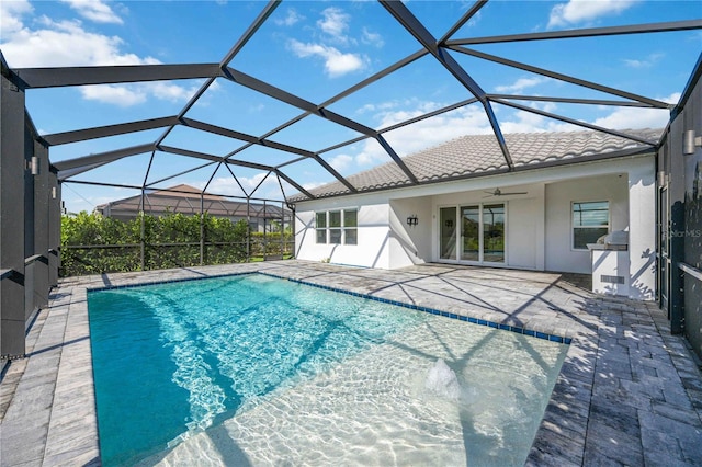 view of pool featuring a patio, ceiling fan, and a lanai