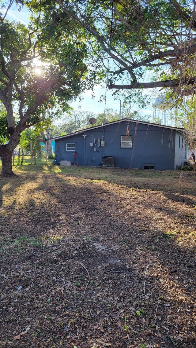 rear view of house featuring central AC unit