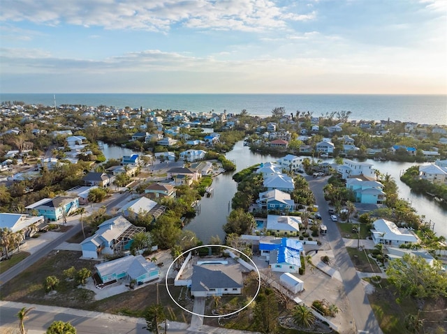 aerial view at dusk featuring a water view