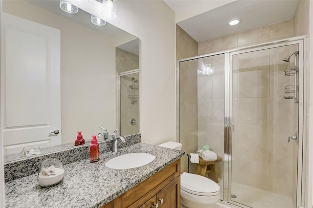 bathroom featuring vanity, toilet, and an enclosed shower