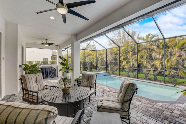 exterior space featuring a lanai, outdoor lounge area, ceiling fan, and a swimming pool with hot tub