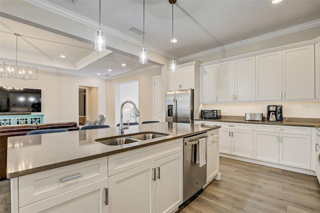 kitchen with white cabinetry, sink, light hardwood / wood-style flooring, a center island with sink, and appliances with stainless steel finishes